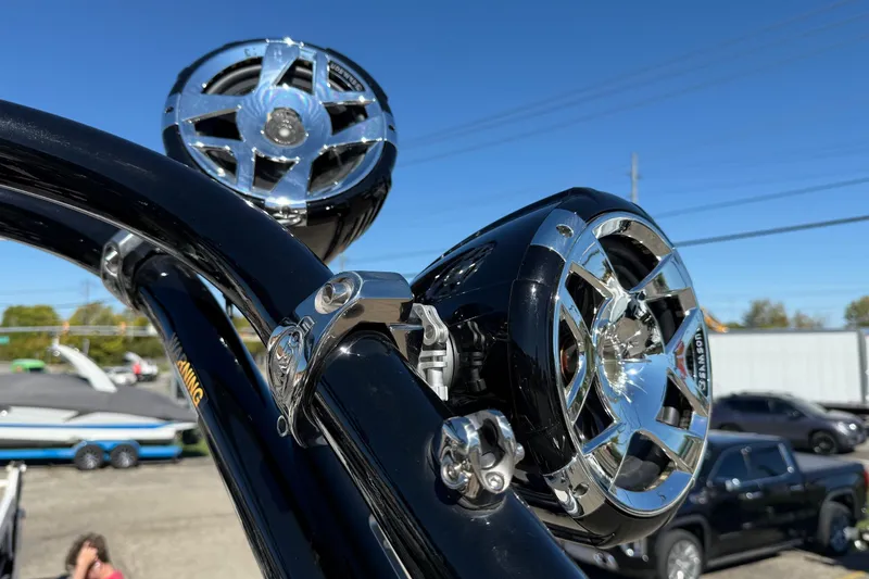 Slide: The Image of 2023 Crownline 240 SS SURF boat speakers with chrome finish under clear blue sky. - 19