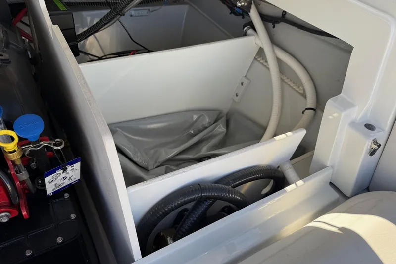 Slide: The Image of 2023 Crownline 240 SS SURF engine compartment with hoses and wiring. - 2