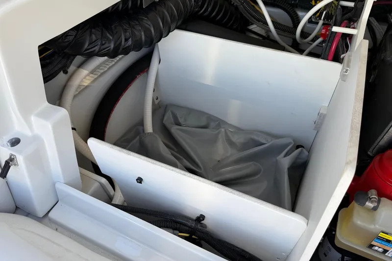Slide: The Image of Engine compartment of 2023 Crownline 240 SS SURF boat, showing hoses and storage area. - 3