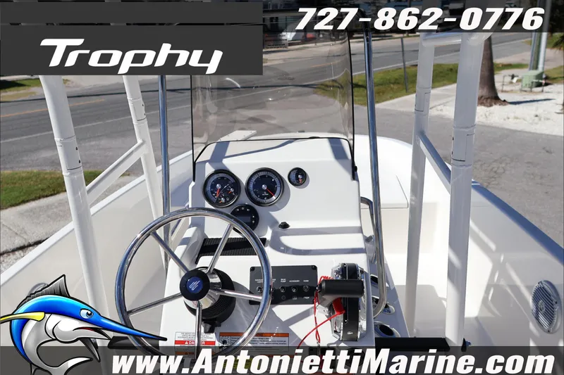 Slide: The Image of 2026 Trophy T18 Bay boat dashboard with steering wheel and gauges, Antonietti Marine contact details. - 12