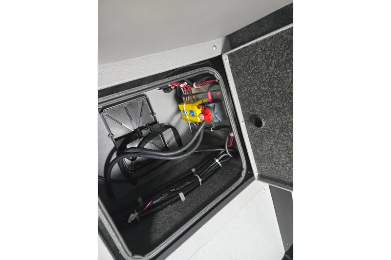 Slide: The Image of 2026 Princecraft Sport 175 boat compartment with wiring and battery components. - 12