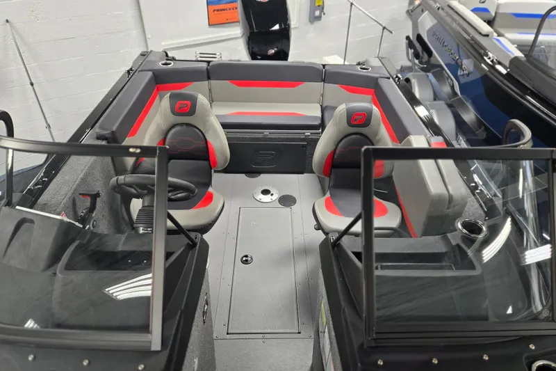 Slide: The Image of 2026 Princecraft Sport 175 boat interior with red and gray seating, dual consoles, and modern design. - 2