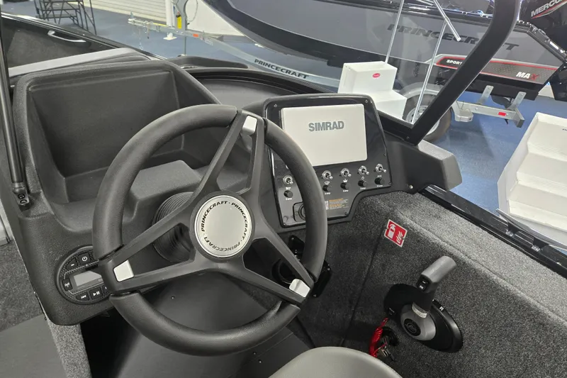 Slide: The Image of 2026 Princecraft Sport 175 boat dashboard with Simrad display and steering wheel. - 5