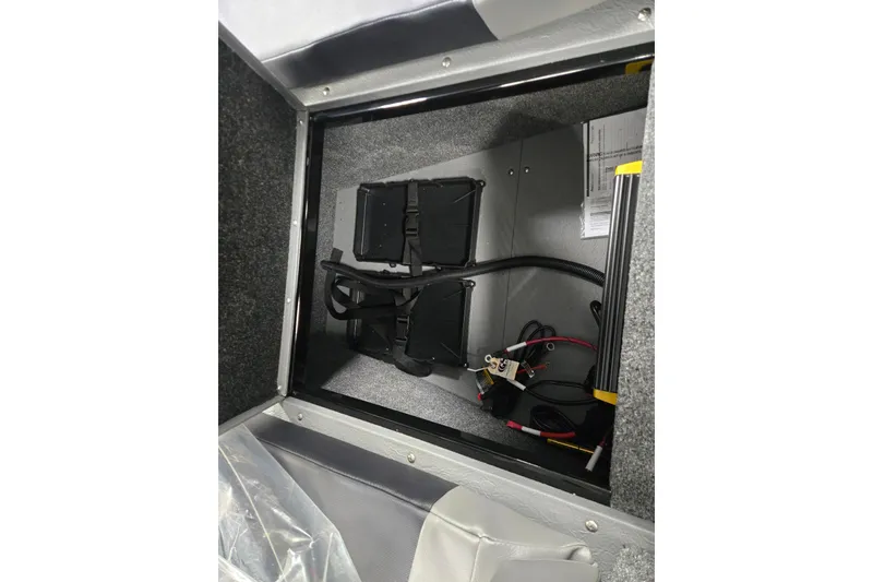 Slide: The Image of Storage compartment of 2026 Princecraft Sport 175 boat, featuring battery and wiring setup. - 7