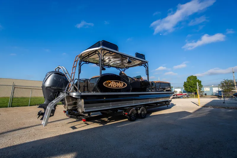 Slide: The Image of 2026 Aloha Paradise 300 Sundeck boat on trailer under clear blue sky. - 3
