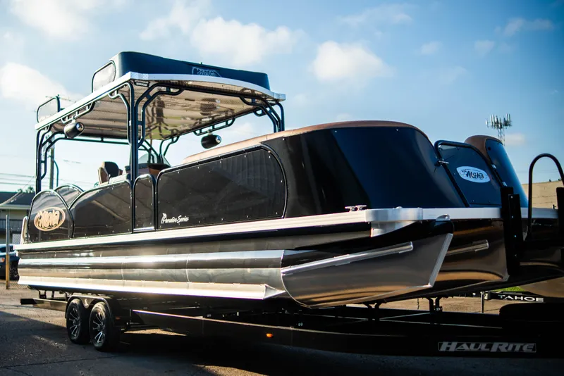Slide: The Image of 2026 Aloha Paradise 300 Sundeck pontoon boat on trailer, sunny day. - 8