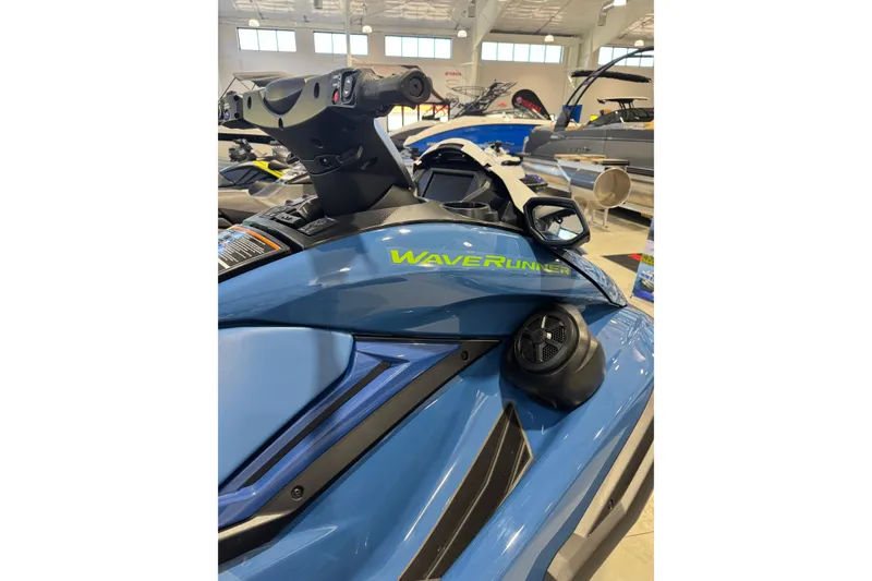Slide: The Image of 2024 Yamaha WaveRunner FX Cruiser SVHO in showroom, showcasing sleek blue design and features. - 2