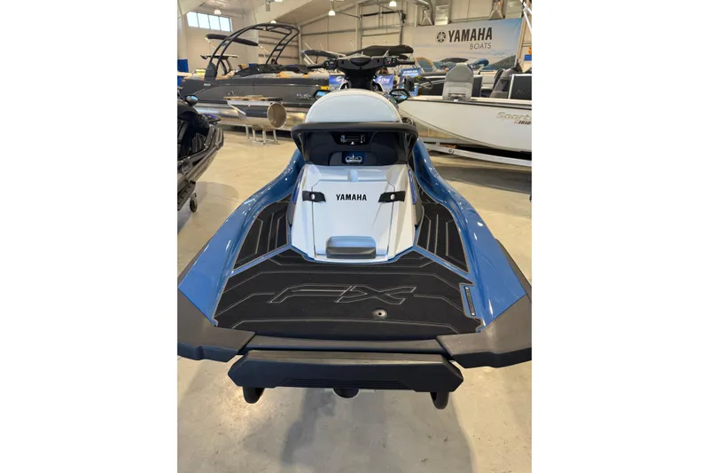 Slide: The Image of 2024 Yamaha WaveRunner FX Cruiser SVHO in showroom, rear view, blue and black design. - 5