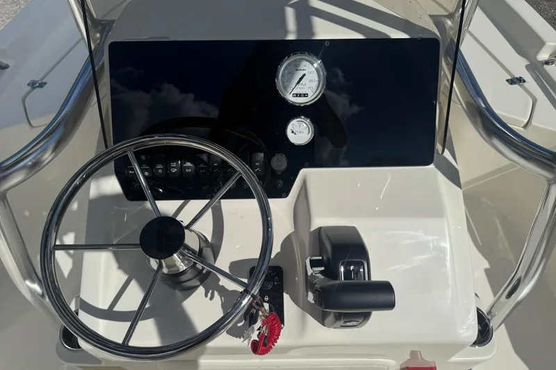 Slide: The Image of 2025 Bulls Bay 2200 boat console with steering wheel and control panel. - 13