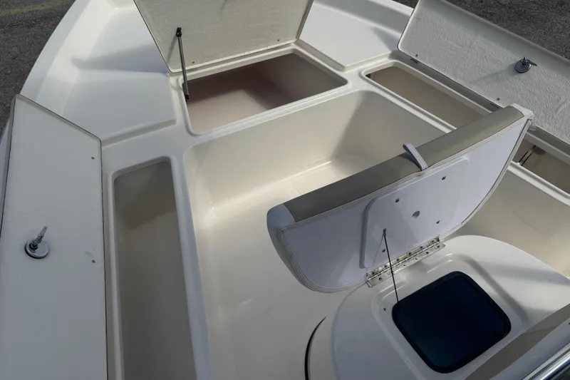Slide: The Image of 2025 Bulls Bay 2200 boat interior with open storage compartments and seating. - 15