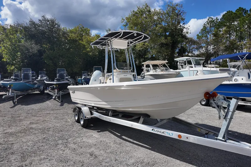 Slide: The Image of 2026 Bulls Bay 2200 boat on trailer, parked outdoors under a cloudy sky. - 2