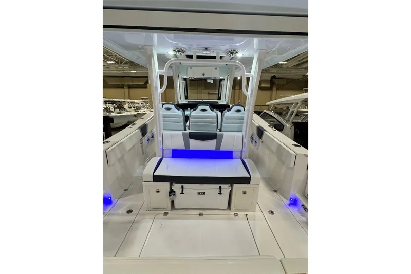Slide: The Image of 2026 Robalo R360 Center Console boat interior with modern seating and ambient lighting. - 26