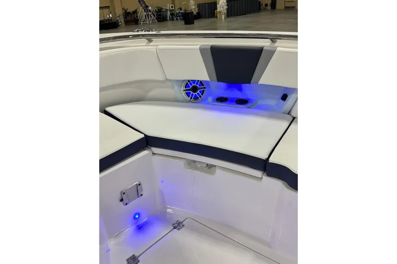 Slide: The Image of 2026 Robalo R360 Center Console boat interior with blue LED lighting and cushioned seating. - 31