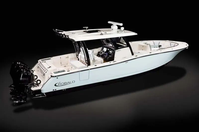 Slide: The Image of 2026 Robalo R360 Center Console cabin interior with seating, sink, and wooden flooring. - 6