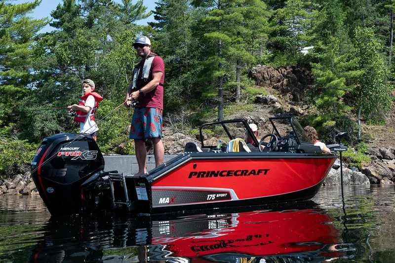 Slide: The Image of Manufacturer Provided Image: 2025 Princecraft Sport 175 MAX boat on a scenic lake with anglers fishing. - 2