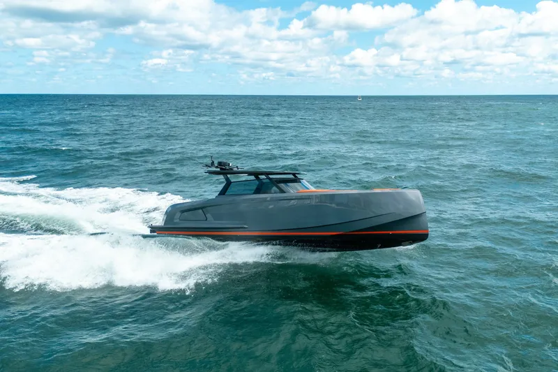 The Image of 2022 Vanquish Yachts VQ45 cruising on open sea with sleek design and luxury seating. - 0