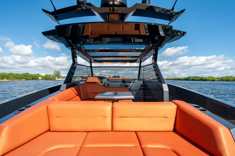 Slide: The Image of Luxurious 2022 Vanquish Yachts VQ45 with orange seating, cruising on a sunny day. - 11