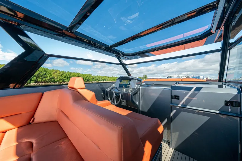 Slide: The Image of Luxurious 2022 Vanquish Yachts VQ45 interior with orange seating and panoramic views. - 17