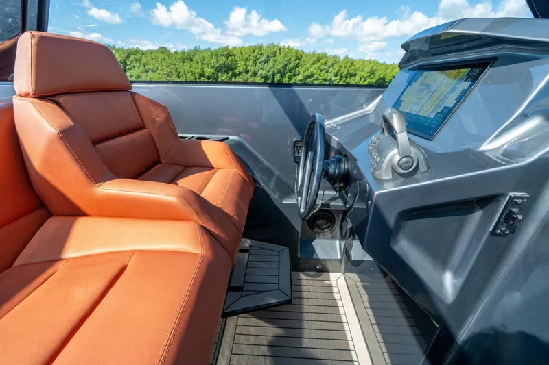 Slide: The Image of Interior of 2022 Vanquish Yachts VQ45 with orange seating and modern dashboard. - 19