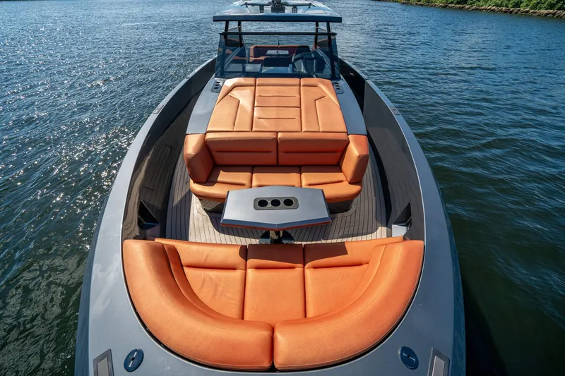 Slide: The Image of 2022 Vanquish Yachts VQ45 luxury yacht with orange seating on open water. - 2
