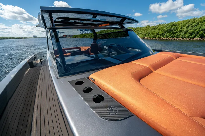 Slide: The Image of 2022 Vanquish Yachts VQ45 with sleek design and luxurious orange seating on open water. - 24