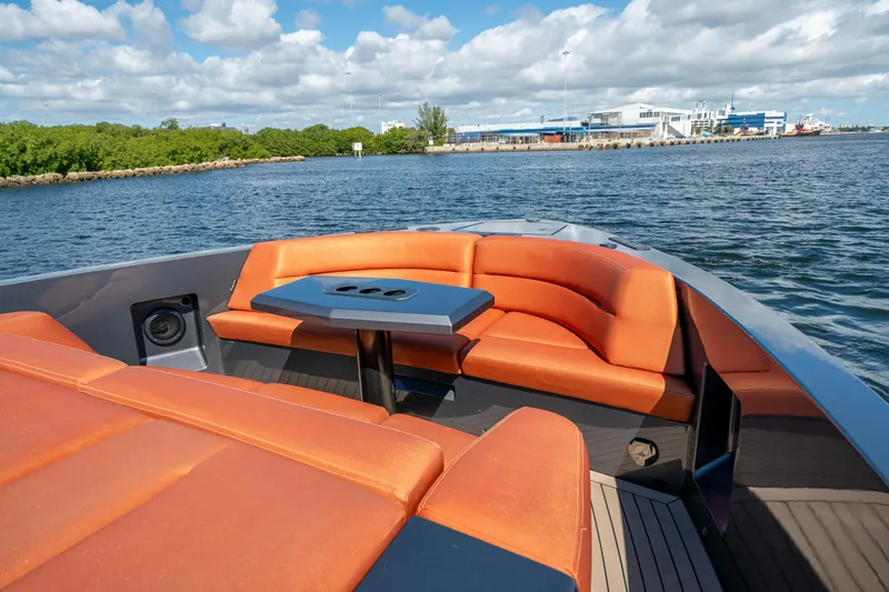 Slide: The Image of Luxurious 2022 Vanquish Yachts VQ45 with orange seating, cruising on a sunny day. - 26