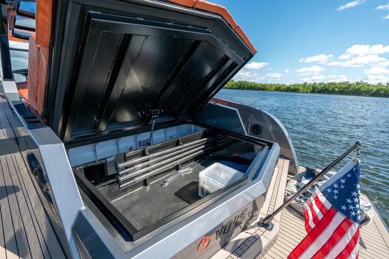 Slide: The Image of 2022 Vanquish Yachts VQ45 storage compartment open on a sunny day by the water. - 36