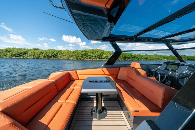 Slide: The Image of Luxurious 2022 Vanquish Yachts VQ45 interior with orange seating and sleek design on the water. - 4