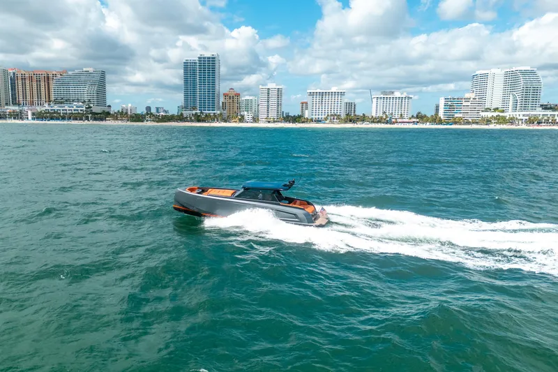 Slide: The Image of 2022 Vanquish Yachts VQ45 cruising on open sea under blue sky. - 47