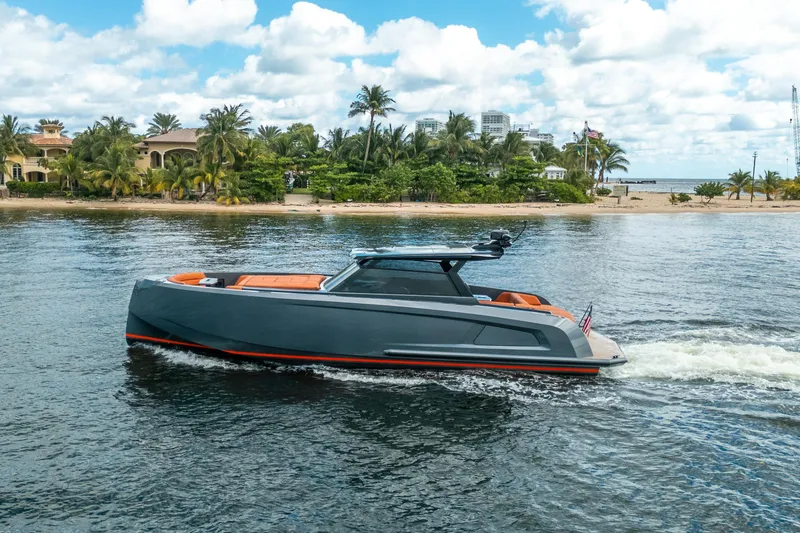 Slide: The Image of 2022 Vanquish Yachts VQ45 cruising near a tropical shoreline with palm trees. - 7
