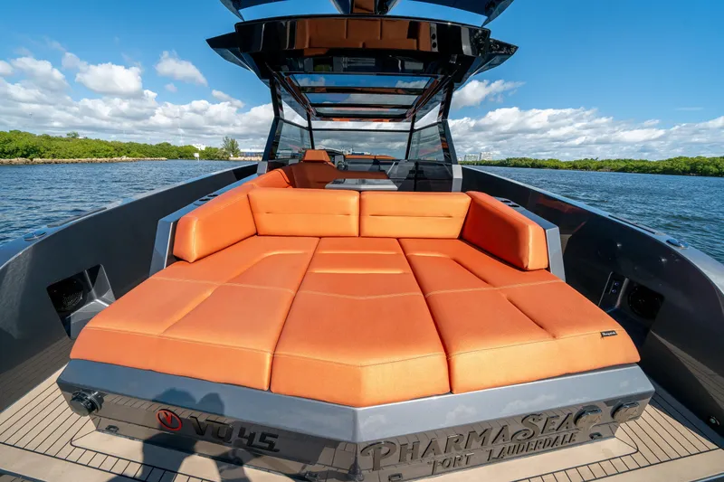 Slide: The Image of 2022 Vanquish Yachts VQ45 with orange seating, cruising on a sunny day. - 8