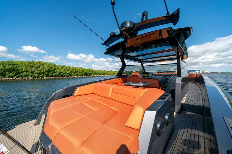 Slide: The Image of 2022 Vanquish Yachts VQ45 with orange seating, sleek design, on a sunny day. - 9