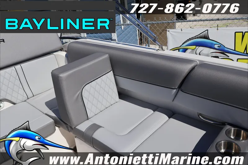 Slide: The Image of 2026 Bayliner D20 boat interior with gray seating, cup holders, and logo. - 14