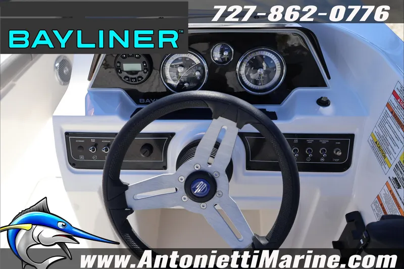 Slide: The Image of 2026 Bayliner D20 boat dashboard with steering wheel and control panel. - 17