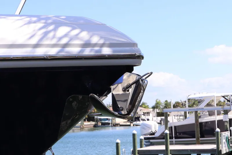 Slide: The Image of 2012 Intrepid 430 Sport Yacht bow with anchor, docked in sunny marina. - 10