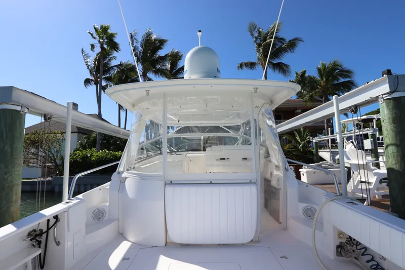 Slide: The Image of 2012 Intrepid 430 Sport Yacht docked, surrounded by palm trees and clear blue sky. - 23