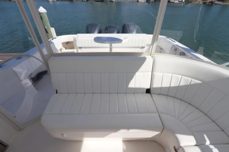 Slide: The Image of 2012 Intrepid 430 Sport Yacht interior with white seating and ocean view. - 28