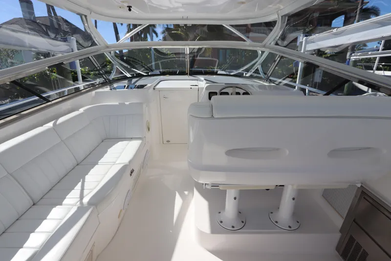 Slide: The Image of 2012 Intrepid 430 Sport Yacht interior with white seating and helm. - 29