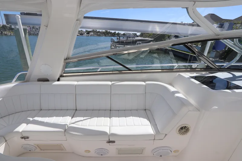 Slide: The Image of Luxurious white seating on 2012 Intrepid 430 Sport Yacht, overlooking marina view. - 30
