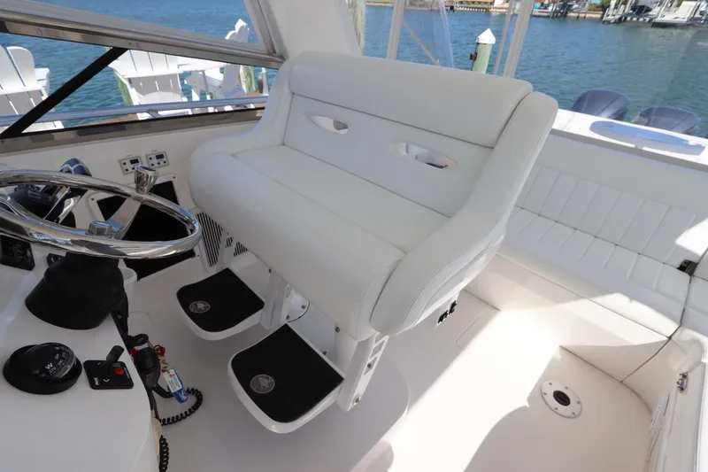 Slide: The Image of Helm seating area of 2012 Intrepid 430 Sport Yacht with steering wheel and controls. - 32