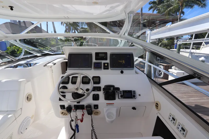 Slide: The Image of Cockpit of 2012 Intrepid 430 Sport Yacht with steering wheel and navigation controls. - 35