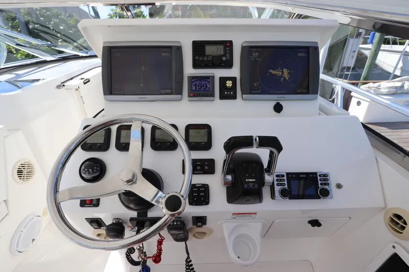 Slide: The Image of Helm of 2012 Intrepid 430 Sport Yacht with navigation screens and controls. - 36