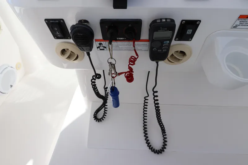 Slide: The Image of Control panel of a 2012 Intrepid 430 Sport Yacht with communication devices and keys. - 40