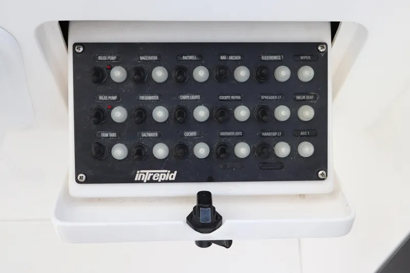 Slide: The Image of Control panel of a 2012 Intrepid 430 Sport Yacht with labeled switches. - 41