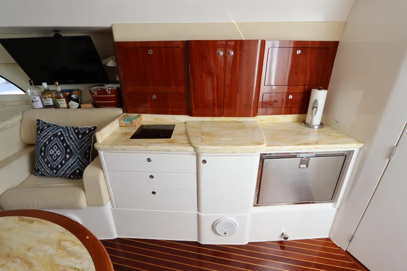 Slide: The Image of Luxurious 2012 Intrepid 430 Sport Yacht interior with elegant kitchenette and seating area. - 48