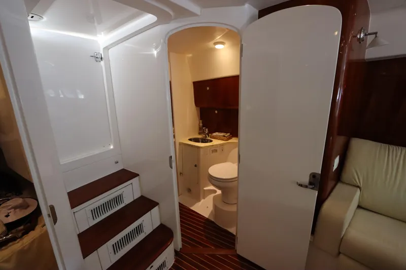 Slide: The Image of Interior of 2012 Intrepid 430 Sport Yacht featuring bathroom and seating area. - 54