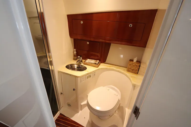 Slide: The Image of Luxurious bathroom in 2012 Intrepid 430 Sport Yacht with wood accents and modern fixtures. - 55