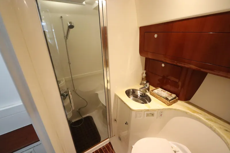 Slide: The Image of Luxurious bathroom in 2012 Intrepid 430 Sport Yacht with shower and wooden cabinetry. - 56