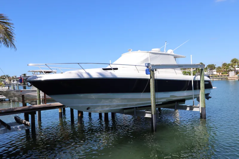 Slide: The Image of 2012 Intrepid 430 Sport Yacht on lift, docked in sunny marina. - 6