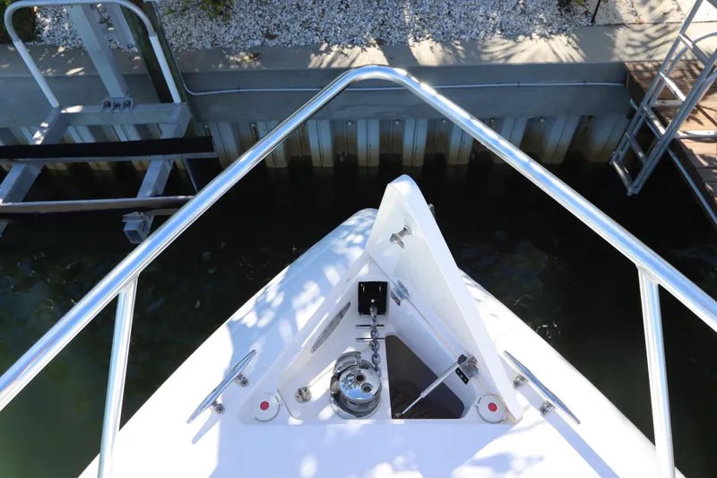 Slide: The Image of Bow view of 2012 Intrepid 430 Sport Yacht docked, featuring stainless steel railings. - 9
